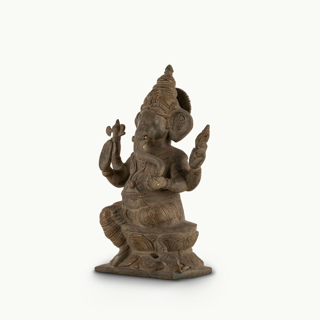 Distressed Brass Ganesha Statue sitting in a regal posture on an east-facing home altar. 
