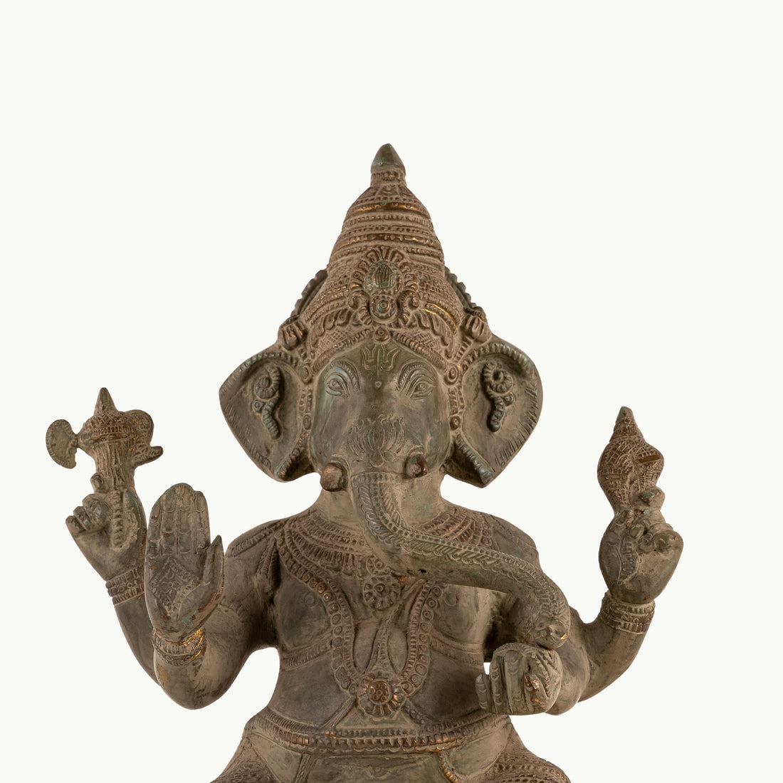 Distressed Brass Ganesha Statue sitting in a regal posture on an east-facing home altar. 