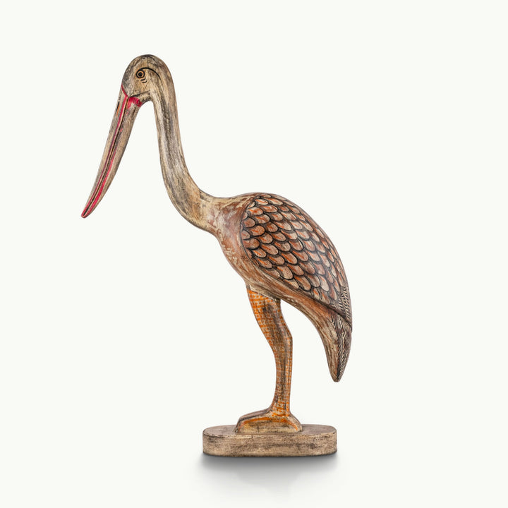 Painted wooden crane sculpture featuring a distressed whitewashed body and orange painted plumage.