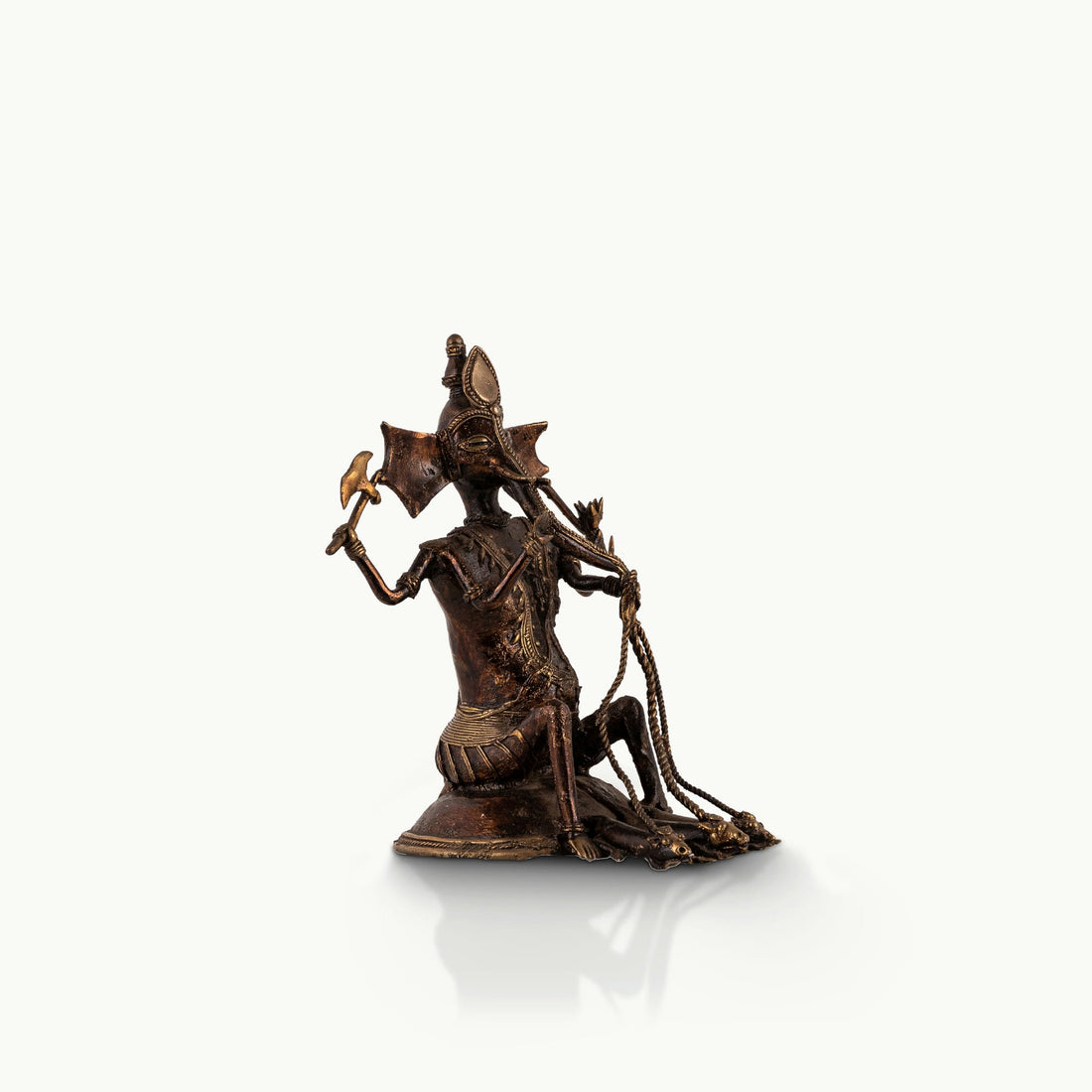 Dhokra Brass Ganesha Statue holding a tribal axe for a light-grained wooden console. 