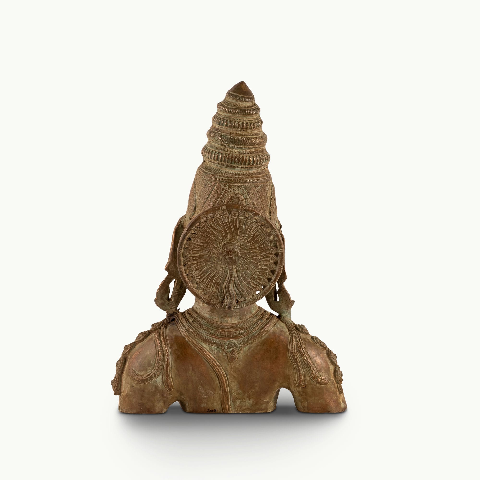 Antique Brass Devi Bust commanding attention with its muted aesthetic on a design-led bookshelf. 