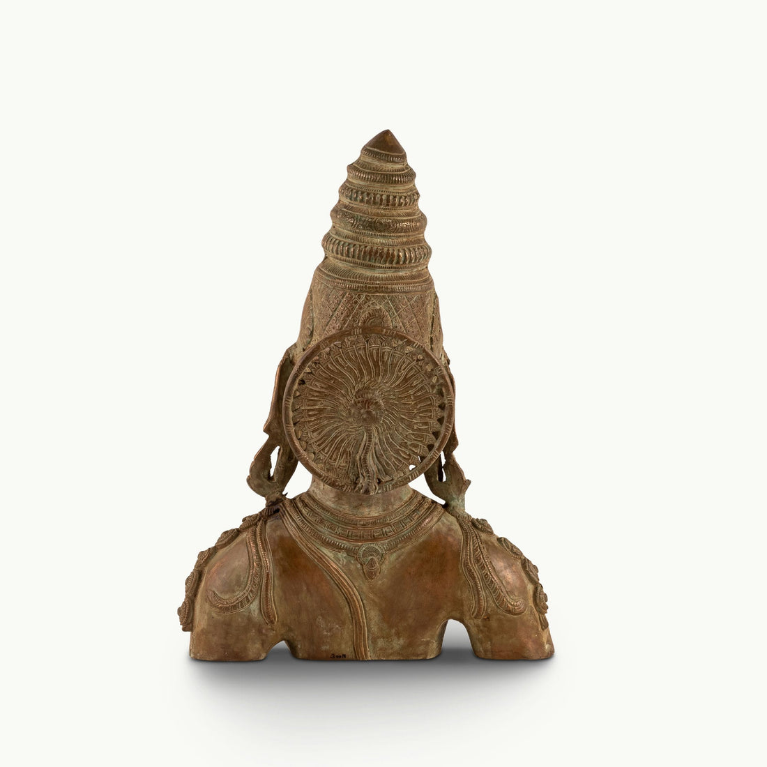 Antique Brass Devi Bust commanding attention with its muted aesthetic on a design-led bookshelf. 