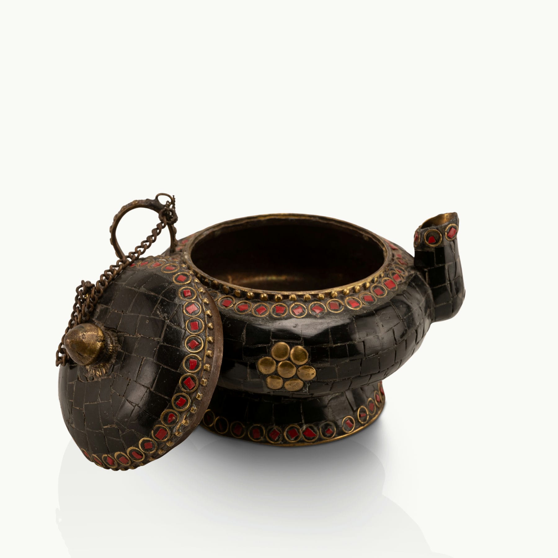 Black Stone Inlay Brass Teapot accented with ruby-red details on a dark walnut sideboard. 