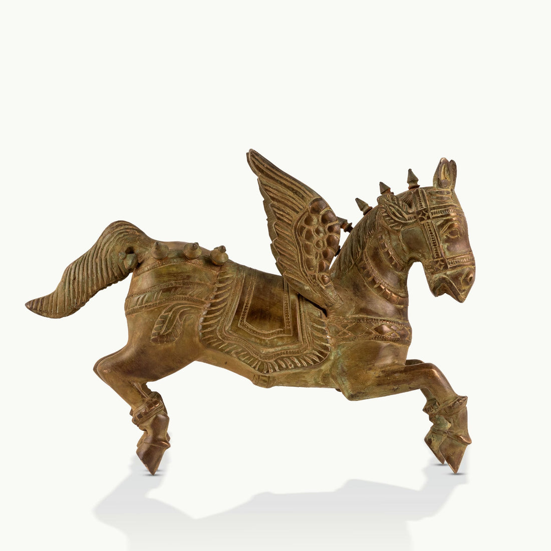Brass Winged Horse Sculpture captured in a dynamic prancing gallop on a home library console. 