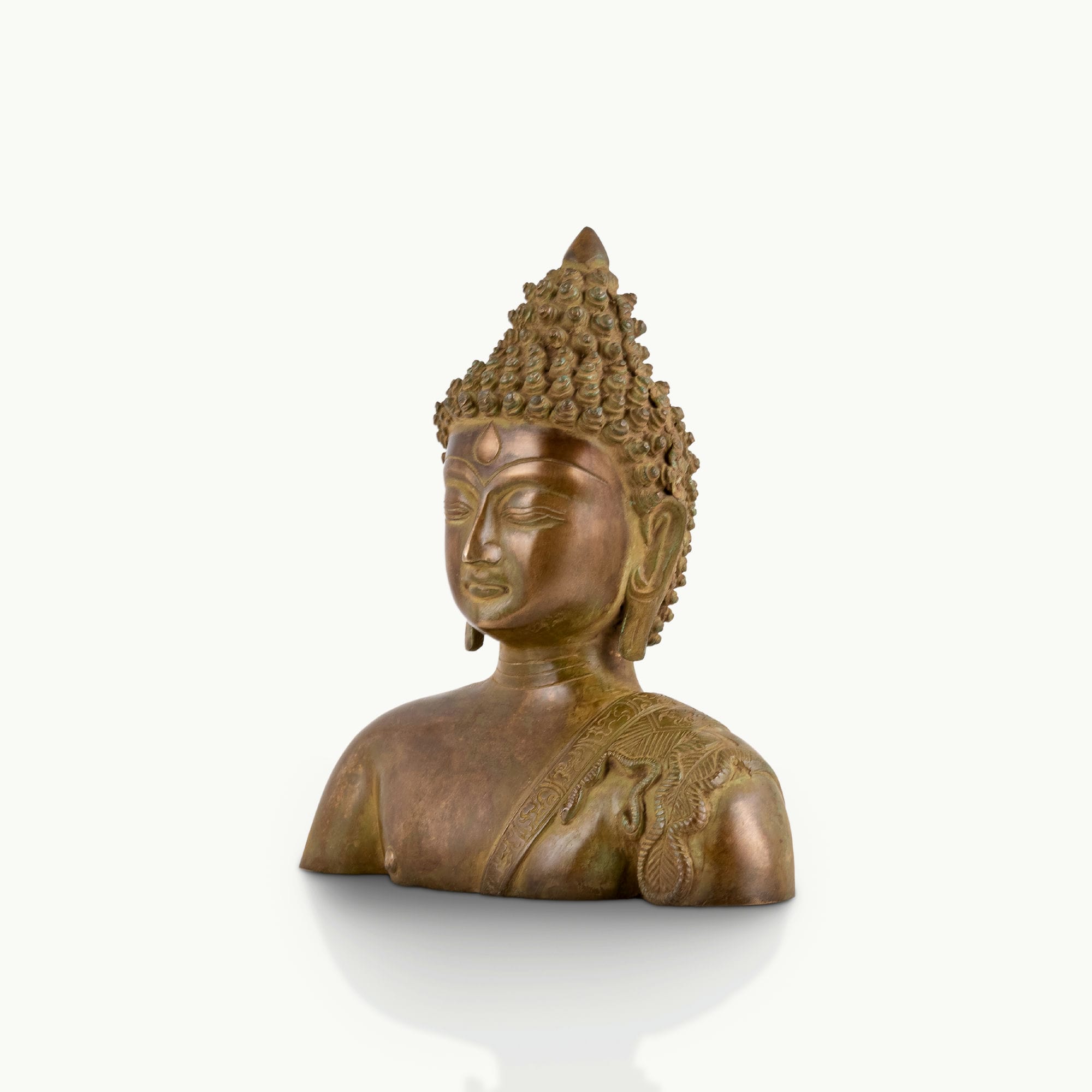 Antique brass Buddha bust featuring a serene face and an engraved robe.