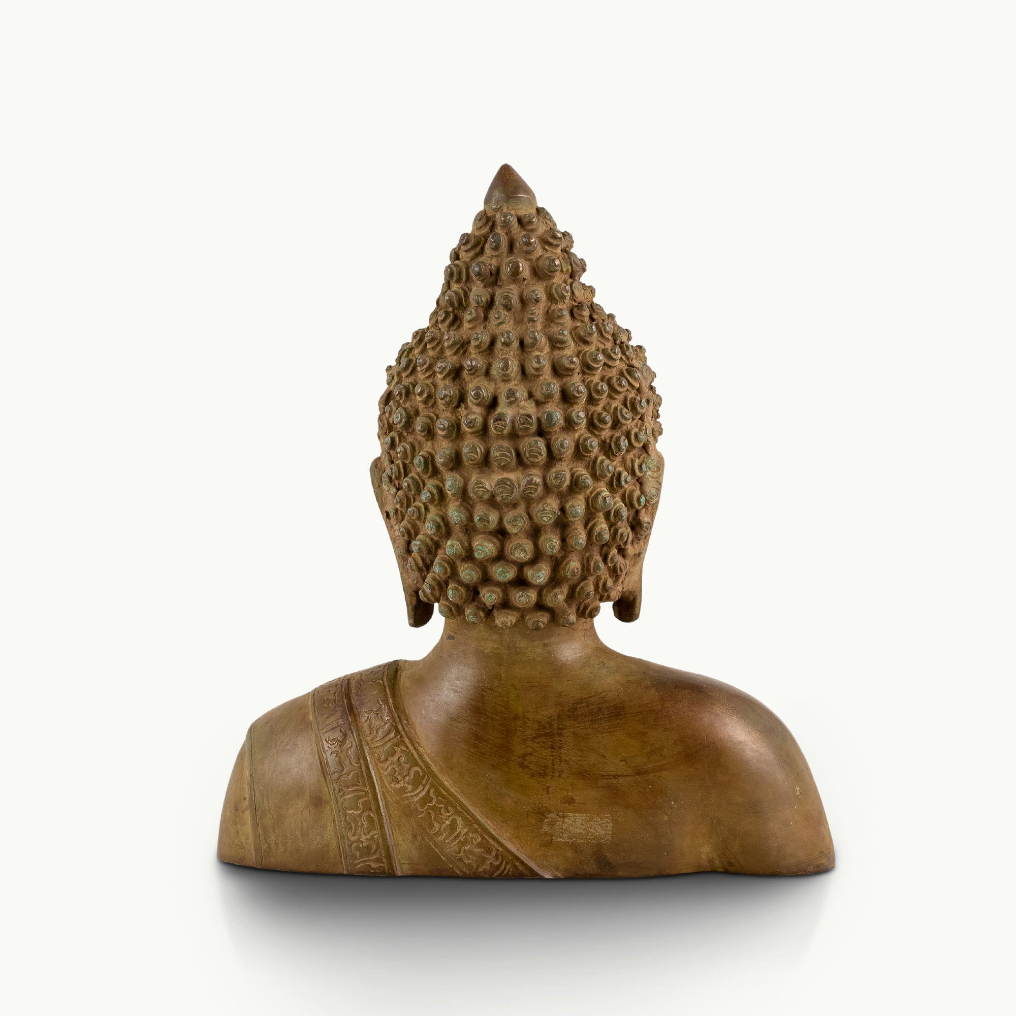 Antique brass Buddha bust featuring a serene face and an engraved robe.