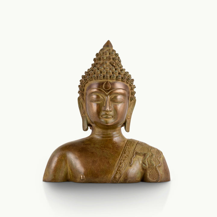 Antique brass Buddha bust featuring a serene face and an engraved robe.