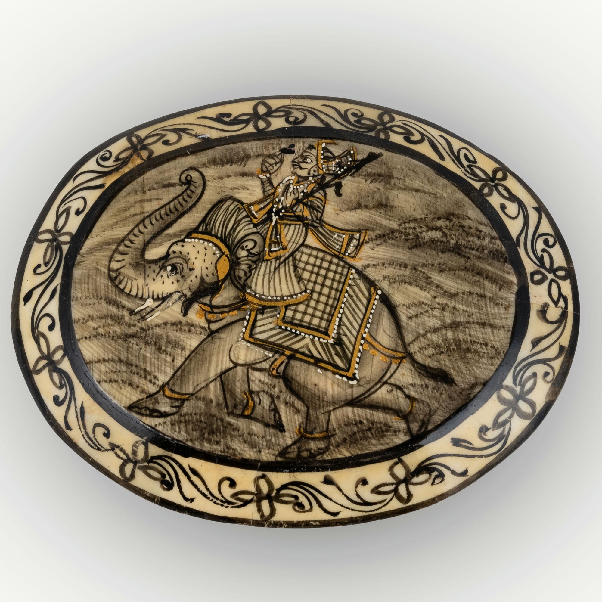 Elephant painted camel bone box featuring a royal rider and curved sword motifs.