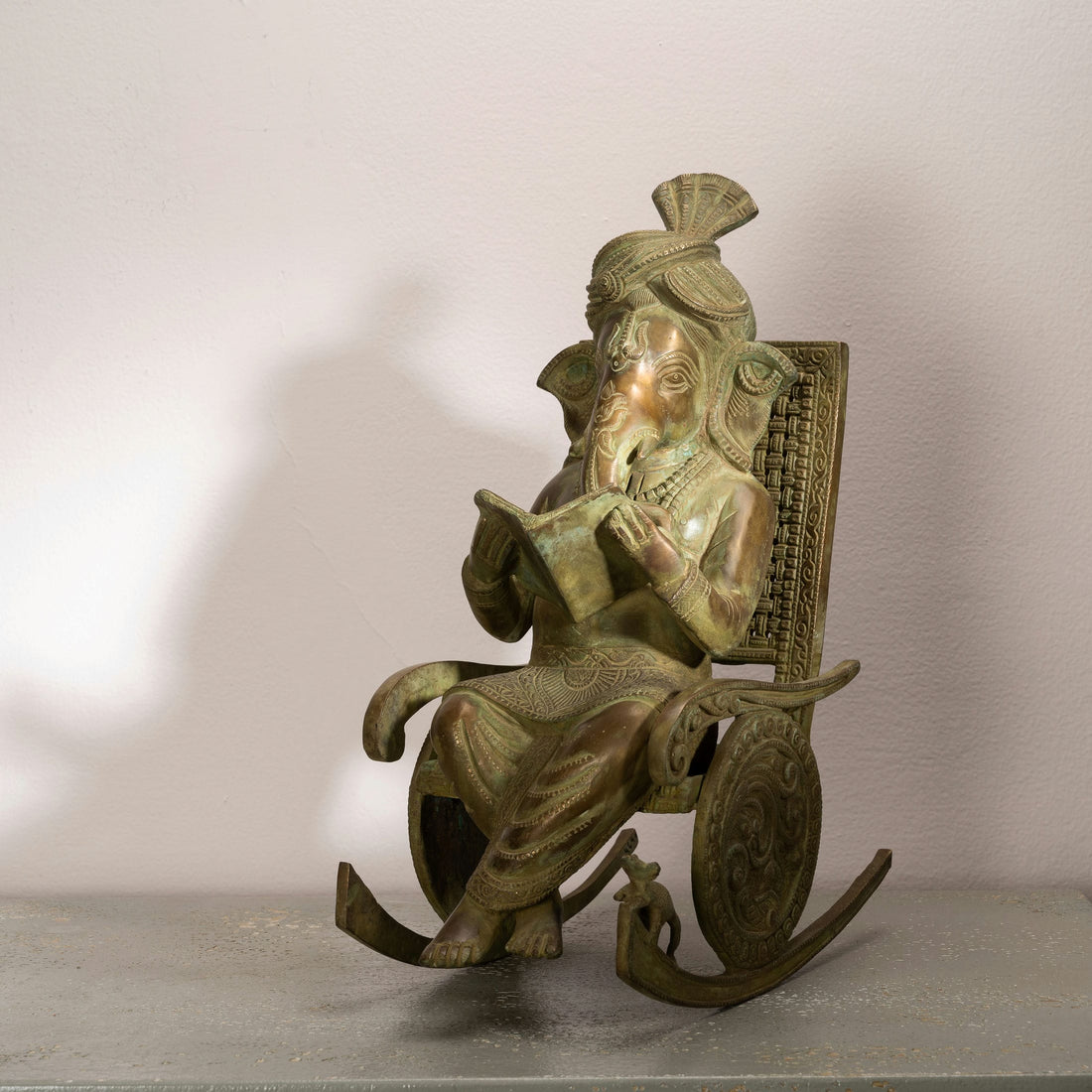 Antique Brass Rocking Chair Ganesha Idol: The Sovereign Scholar