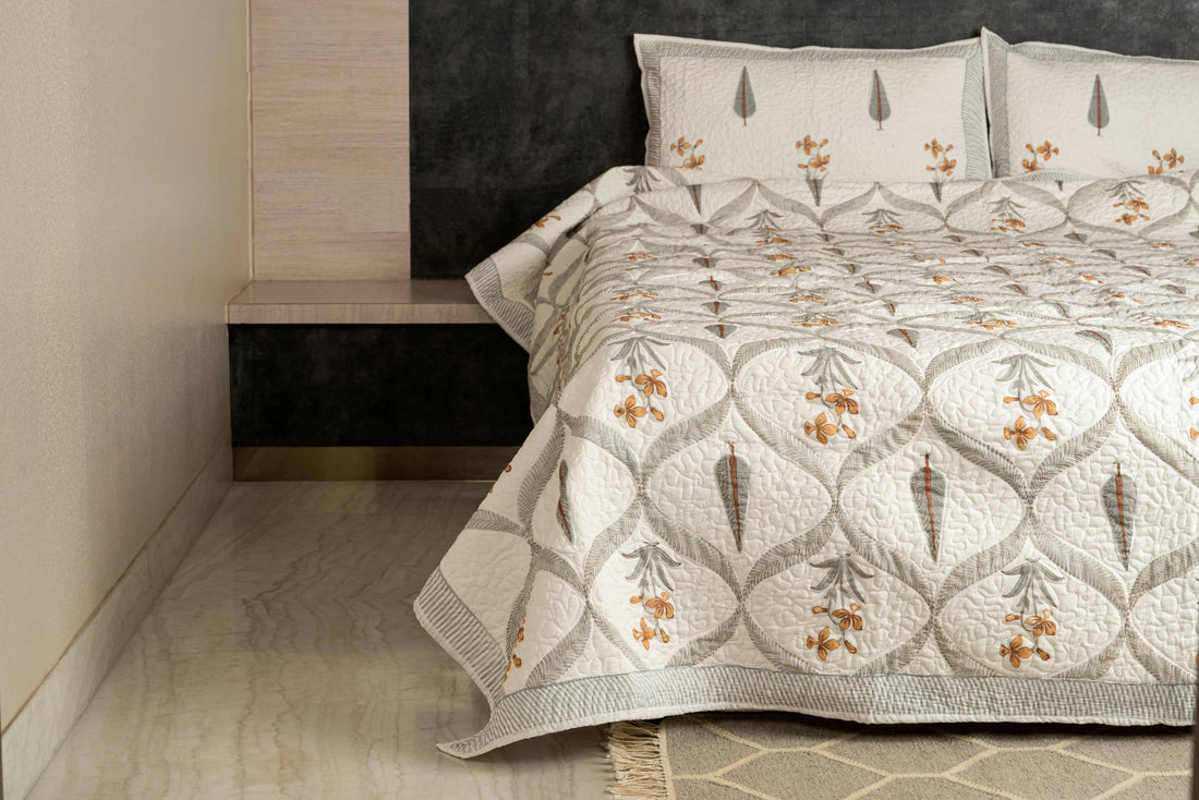 Hand-stitched cotton quilted coverlet with feather and blossom ogee pattern