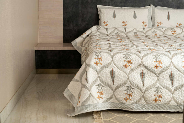 Hand-stitched cotton quilted coverlet with feather and blossom ogee pattern