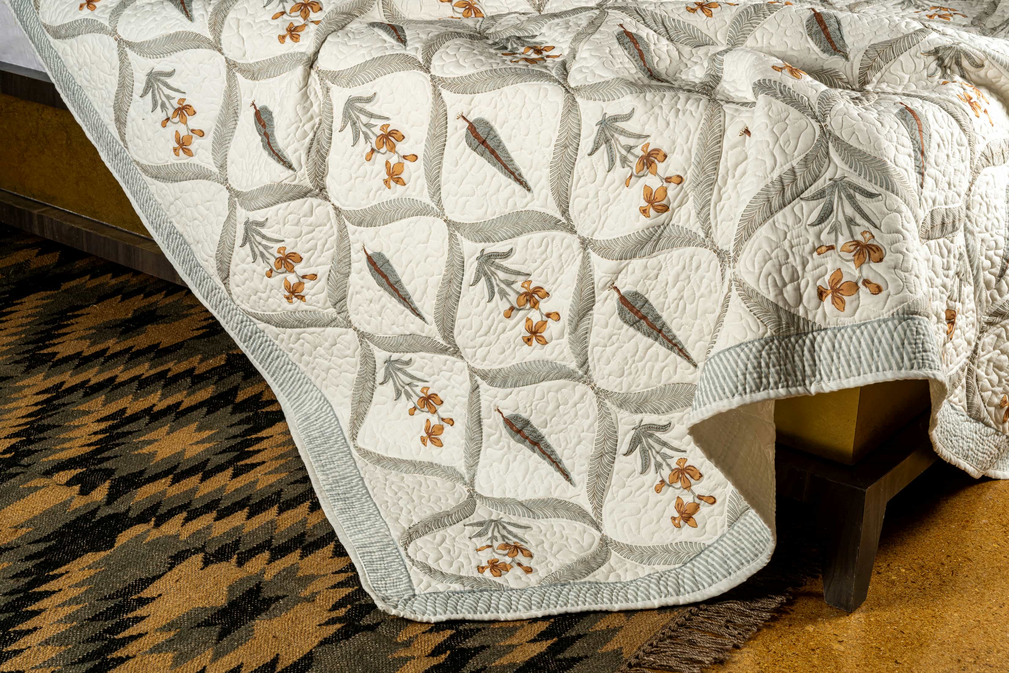 Hand-stitched cotton quilted coverlet with feather and blossom ogee pattern
