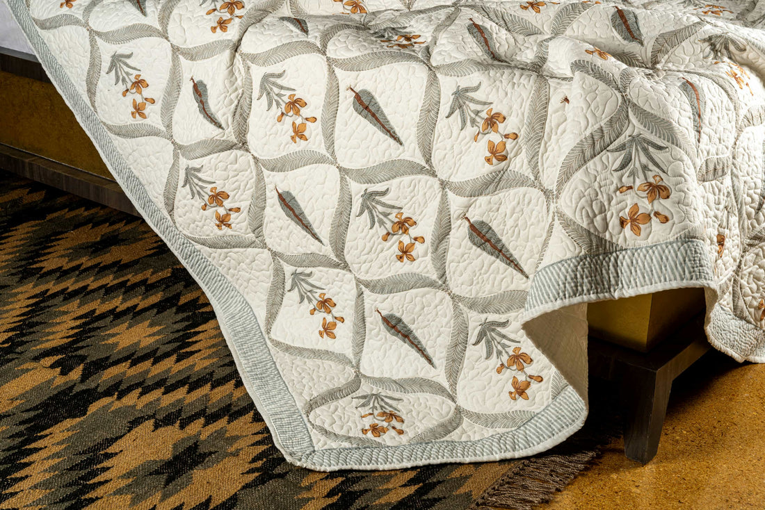 Hand-stitched cotton quilted coverlet with feather and blossom ogee pattern