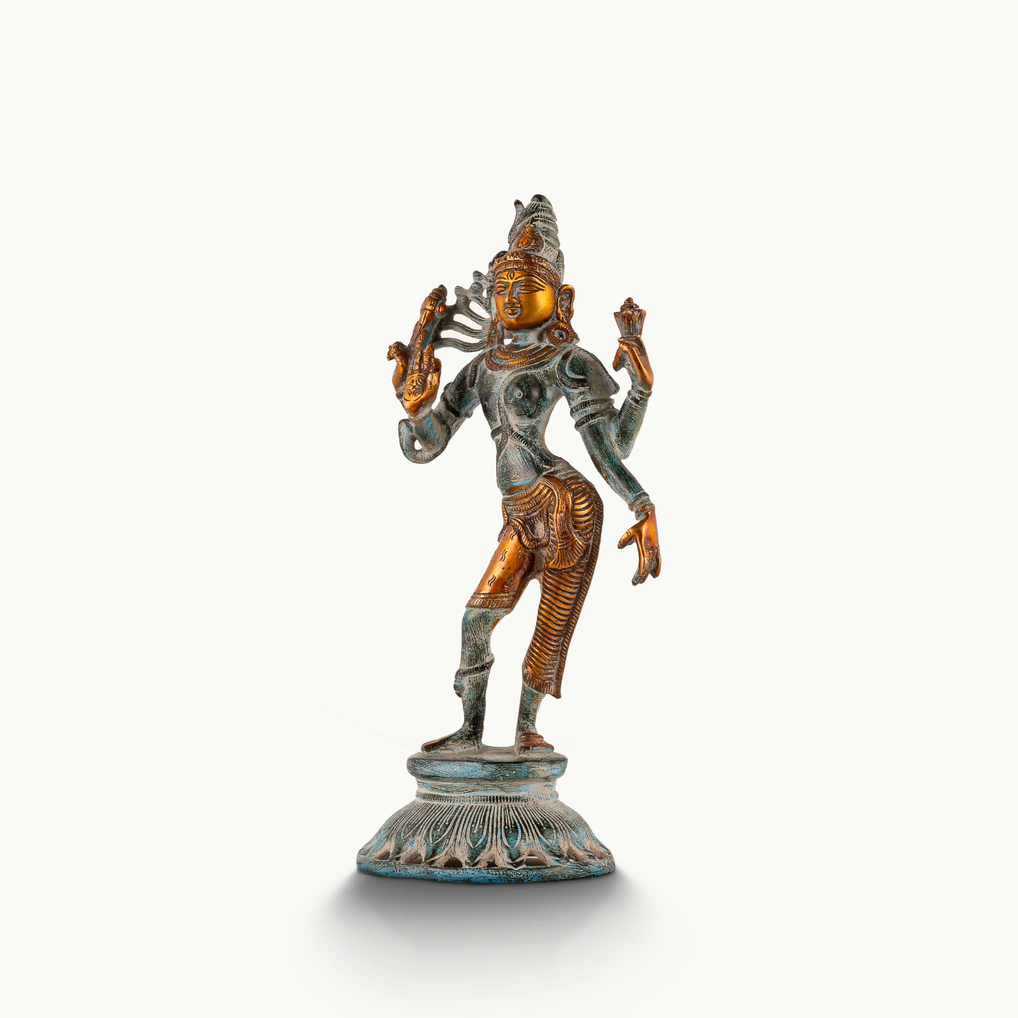 Dual-tone Shiva Shakti metal idol with a polished gold-tone face and teal patina for a foyer console or housewarming gift.