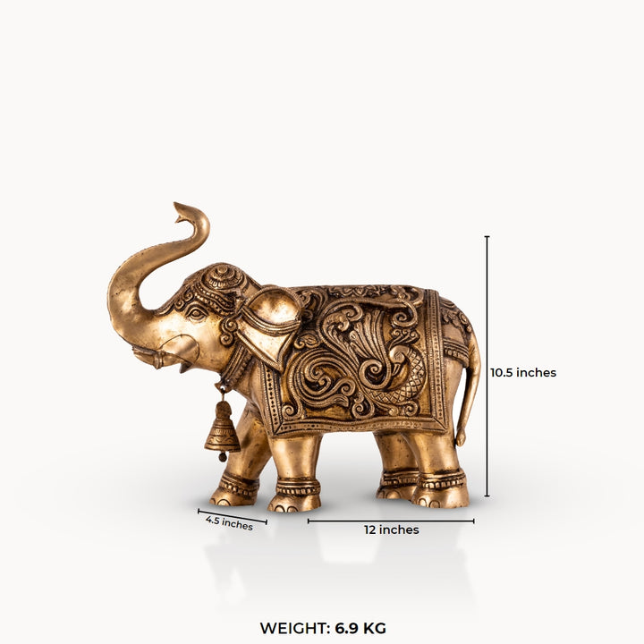 Engraved Golden Brass Elephant with a raised trunk for a dark walnut executive desk.