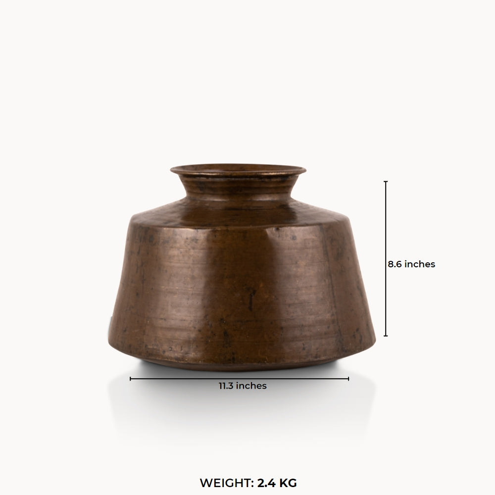 Large Antique Brass Handi with a wide conical shoulder for a light-wood entryway console.