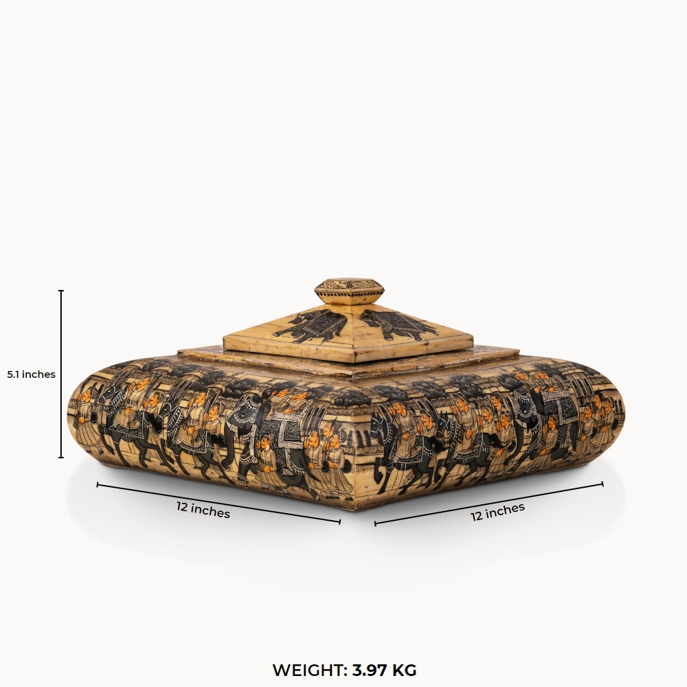 Square painted camel bone box depicting a Rajput royal procession on a dark vanity.