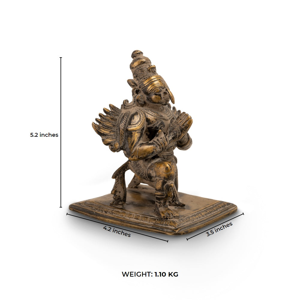 Antique Brass Garuda Statue kneeling in eternal devotion on a home altar. 