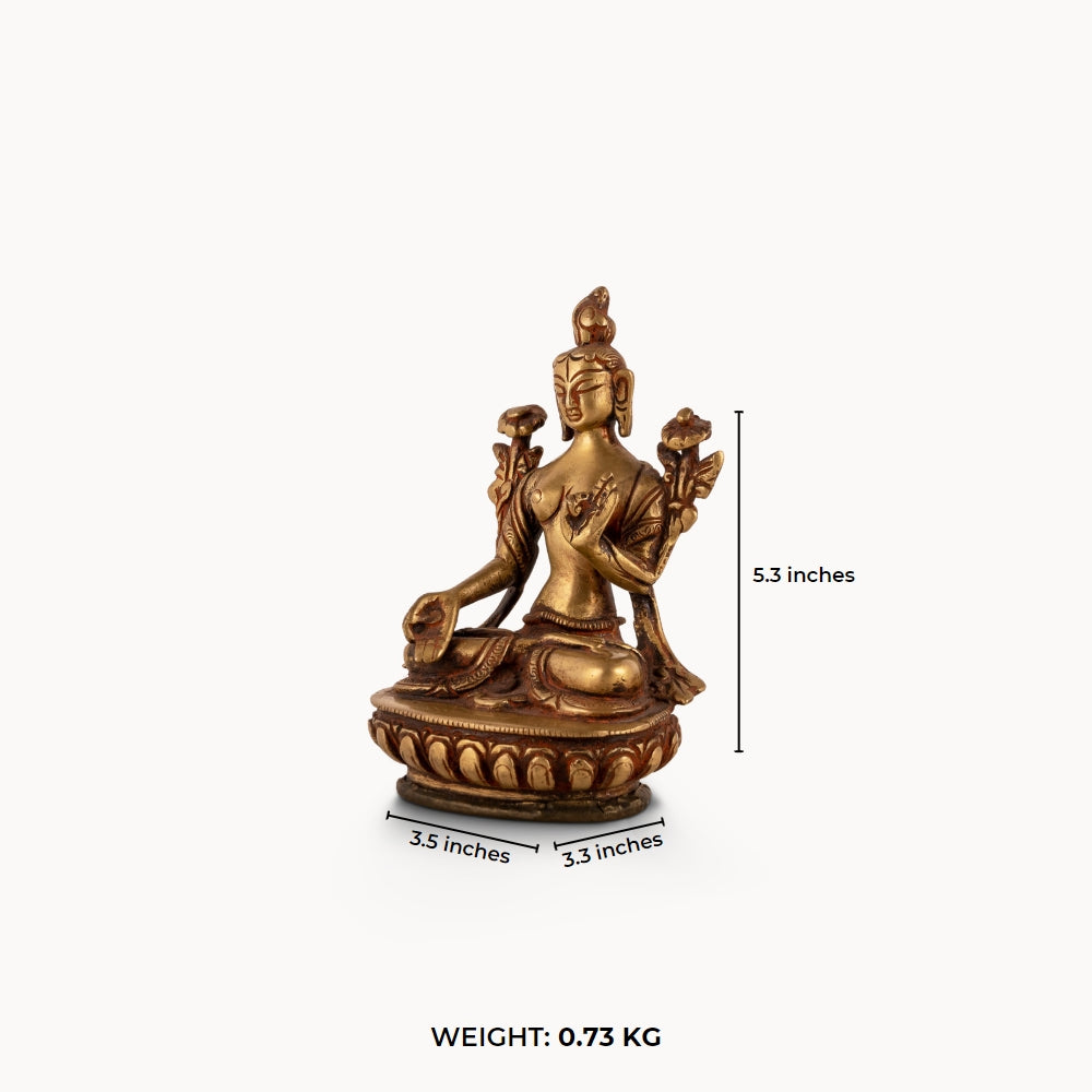 Polished Brass Tara Statue emerging from stylized lotus petals on a bedside table. 