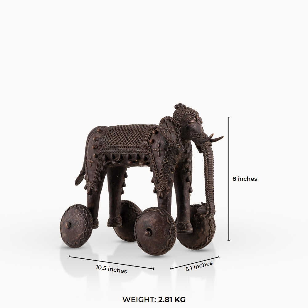 Dhokra Brass Wheeled Elephant ready for a ceremonial procession on a reclaimed wood coffee table. 