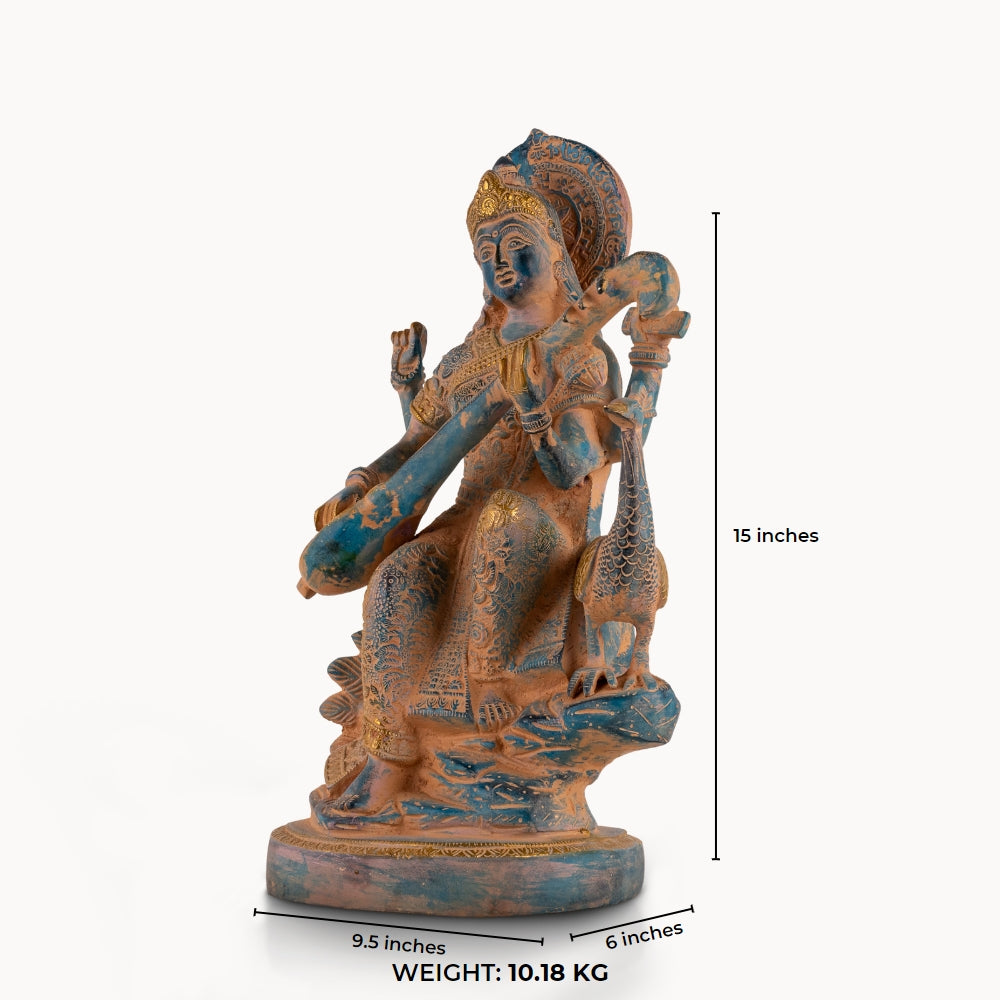 Dual-Tone Brass Saraswati Statue cradling a veena gracefully on a dedicated library console. 