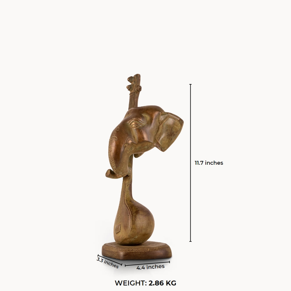 Antique Brass Musical Elephant merging with a veena for a dark walnut desk.