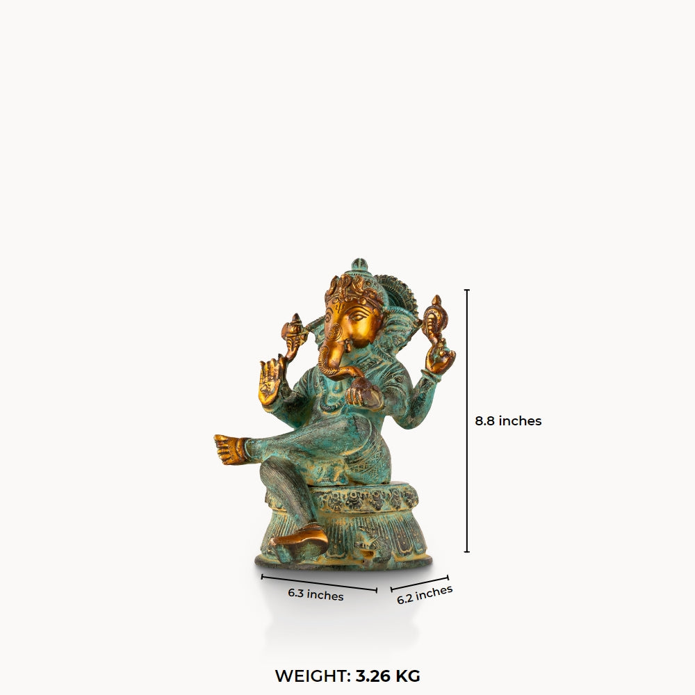 Verdigris Brass Seated Ganesha in a relaxed Lalitasana for a light-wood console.
